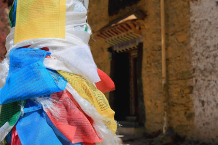 Pole post wrapped in five colored buddhist prayer flags. Way down from the main buildings of Drak Yerpa monasterycomplex of more than 80 meditation caves. Lhasa pref.Tibet.のeditorial素材