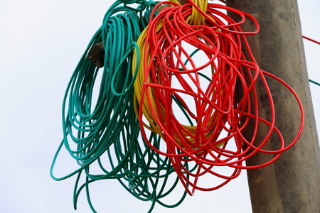 Tangled colorist electrical wires set on an utility pole on a street of a hamlet on the banks of the Yarlung Tsangpo-river near Shigatse city-county and pref. Tibet.の写真素材
