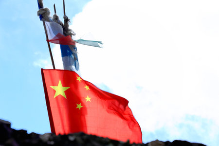 Chinese flag on roof of building on grounds of the 1073 AD.Khon Konchog Gyalpo founded North Seat of...