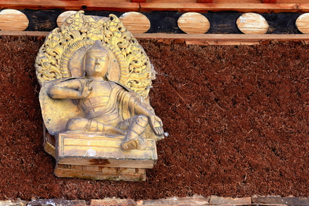 Gilded Buddha relief-wood and red heather wall-shrine on Ponpori Hillの写真素材