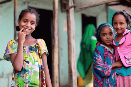 DEGAN, ETHIOPIA-MARCH 25: Local young girls on their way to school cross the khat market being held...