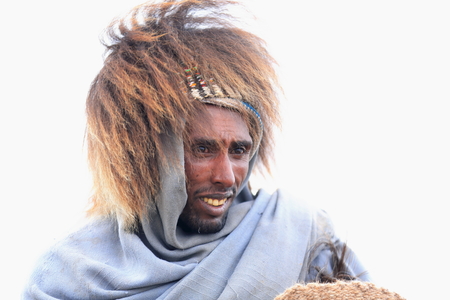 DEBRE BIRHAN, ETHIOPIA-MARCH 30: Amharic man wears baboon gelada hair hat as example of the local use for headdresses on March 30, 2013 in Menelik's Window mountain gorge near Debre Sina-Amhara regionのeditorial素材