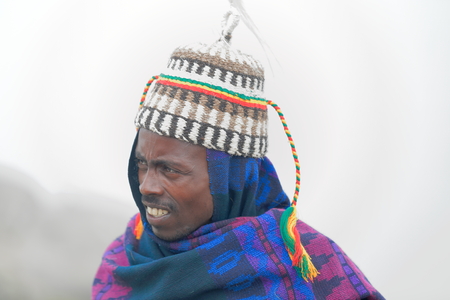 DEBRE BIRHAN, ETHIOPIA-MARCH 30: Amharic man wears horse hair hat as example of the local use for headdresses on March 30, 2013 in Menelik's Window mountain gorge near Debre Sina-Amhara regionのeditorial素材