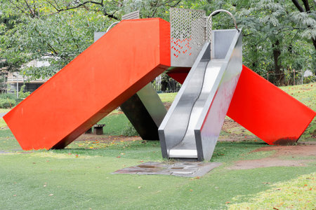 Hinokicho Koen-park is an urban oasis behind the Tokyo Midtown complex with a landscaped garden-small lake-the 21 21 Design Sight museum-green space and playground with 2 aluminum slides. Tokyo-Japan.のeditorial素材