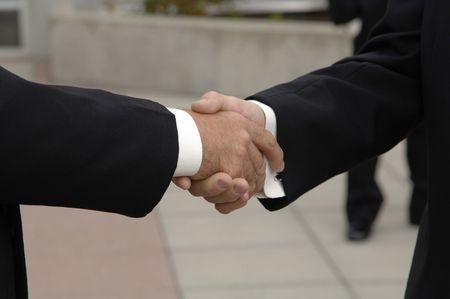 Friends shaking hands at weddingの写真素材