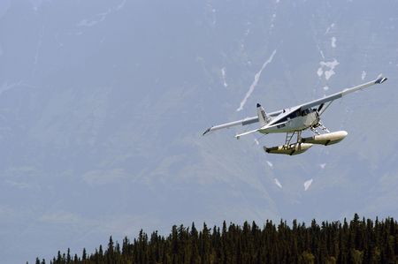 Float plane taking off a lake in Alaskaの写真素材