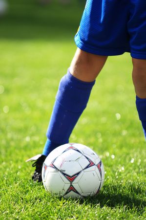 Soccer ball at bottom of soccer player's feetの写真素材