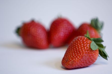 One strawberry in focus with others out of focusの写真素材