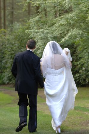 Bride and groom walking awayの写真素材