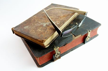 Glasses on antique booksの写真素材