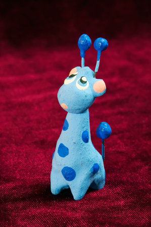 Toy blue giraffe on redの写真素材