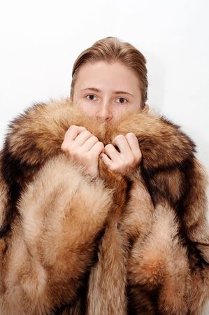 Woman in fur of racoonの写真素材