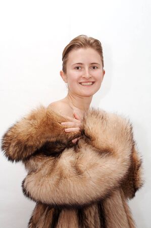Woman in fur of racoonの写真素材