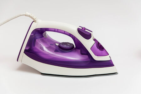 Purple iron for Ironing on a white backgroundの写真素材