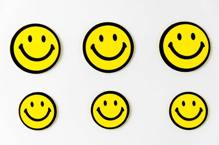 Smiley face symbol note hanging on the ropeの写真素材