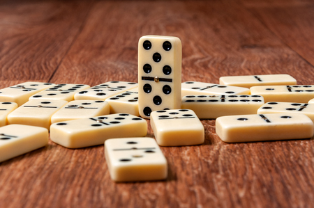 domino pieces on the brown wooden table background.の写真素材