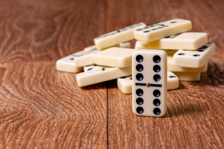 domino pieces on the brown wooden table background.の写真素材