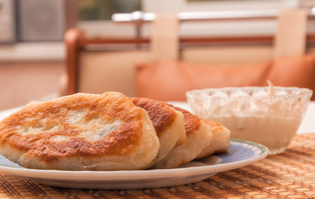 Ukrainian homemade meat pies on a plate on a white tablecloth.