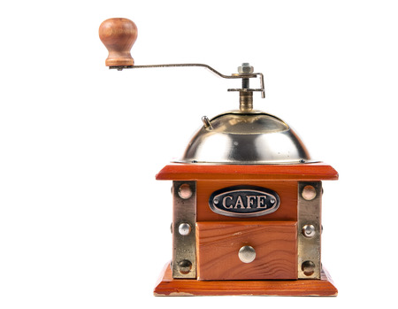 Photo of an antique coffee grinder isolated on a white background.の写真素材