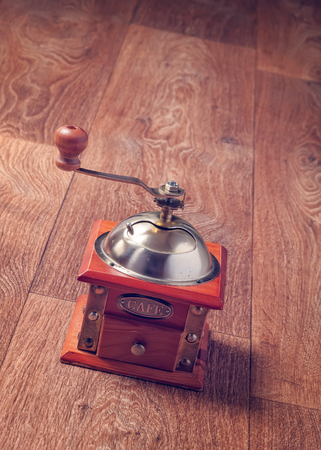 Retro coffee grinder on wooden background. Old manual coffee grinderの写真素材