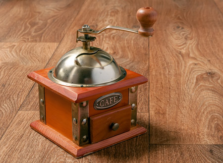 Retro coffee grinder on wooden background. Old manual coffee grinderの写真素材