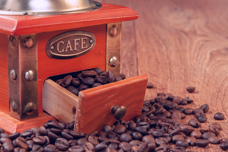Vintage manual coffee grinder with beans. Retro coffee grinderの写真素材