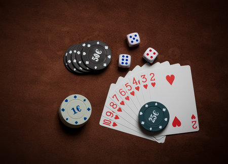 Poker chips and generic playing cards. Courts for poker chips and dice on tableの写真素材