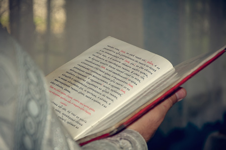 Orthodox christian priest reading church book. The rite of baptism in the Churchの写真素材