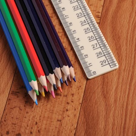 Colored pencils and ruler for schools on wooden background.の写真素材
