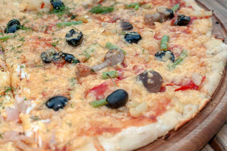 Delicious italian pizza served on wooden tableの写真素材