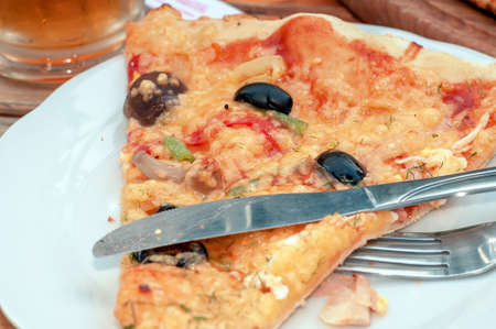 Homemade pizza on baking paper close up.の写真素材