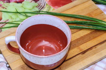 Empty tureen dishes and green onions on the tableの写真素材
