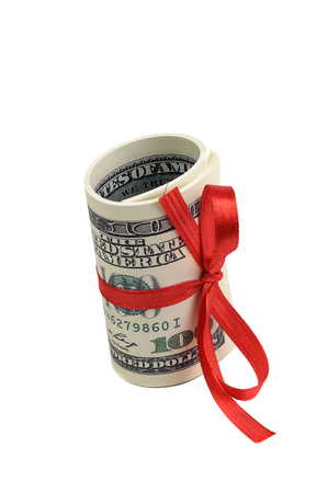 Bundle of bills of one hundred dollars tied with a red ribbon. Dollars isolated on white background.の写真素材