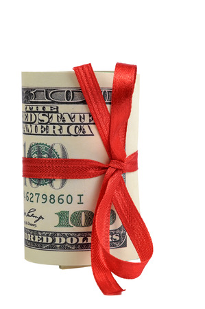 Bundle of bills of one hundred dollars tied with a red ribbon. Dollars isolated on white background.の写真素材