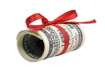 Bundle of bills of one hundred dollars tied with a red ribbon. Dollars isolated on white background.の写真素材