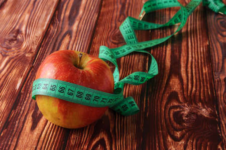 Fresh, ripe apples on an old wooden table. Fruit to comply with the dietの写真素材