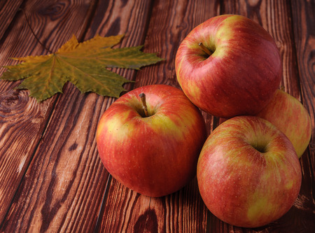 Fresh, ripe apples on an old wooden table. Fruit to comply with the dietの写真素材