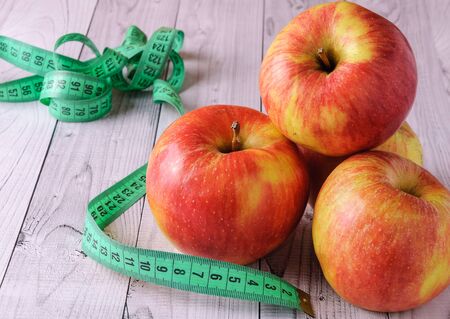 Fresh, ripe apples on an old wooden table. Fruit to comply with the dietの写真素材