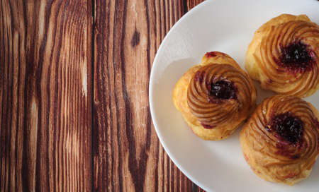 Cakes of cottage cheese with fruit jam, on an old wooden background.の写真素材