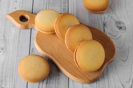 Delicious biscuits with banana filling on an old wooden table. Sweet dessert.の写真素材