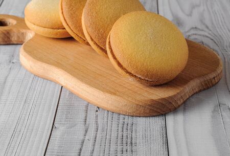 Delicious biscuits with banana filling on an old wooden table. Sweet dessert.の写真素材