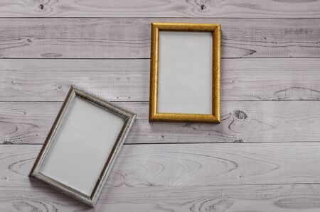 Two frames for photos on a light, vintage wooden backgroundの写真素材