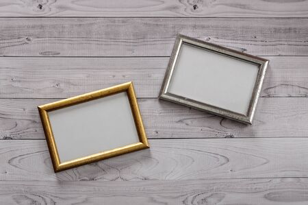 Two frames for photos on a light, vintage wooden backgroundの写真素材