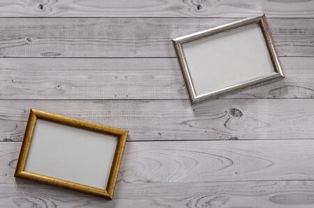 Two frames for photos on a light, vintage wooden backgroundの写真素材