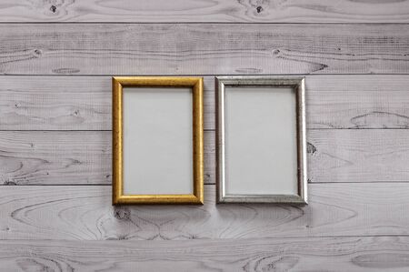 Two frames for photos on a light, vintage wooden backgroundの写真素材