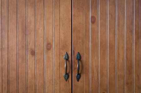 A closeup of wooden doors with metal handles.の写真素材