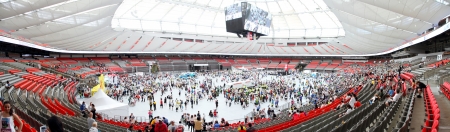 VANCOUVER, CANADA - April 21, 2013 - Participants having just completed the Vancouver Sun Run visit different refueling stations inside BC Place in Vancouver, Canada.のeditorial素材