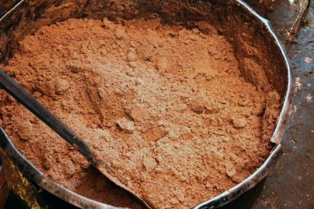 A large metal vat of ground peanuts before adding oil to make peanut butter の写真素材
