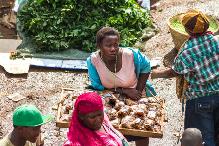 KAMPALA, UGANDA - OCTOBER 03, 2012.  A girl looks bored while selling food at the taxi park in Kampala, Uganda on October 03,2012.のeditorial素材