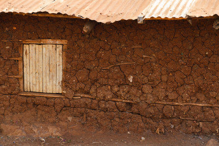 A mud hut home with a window inside the Kibera slum of Nairobi, Kenya